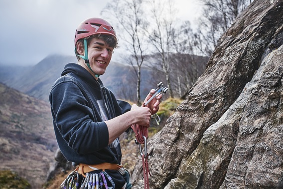 a student rock climbing a student rock climbing