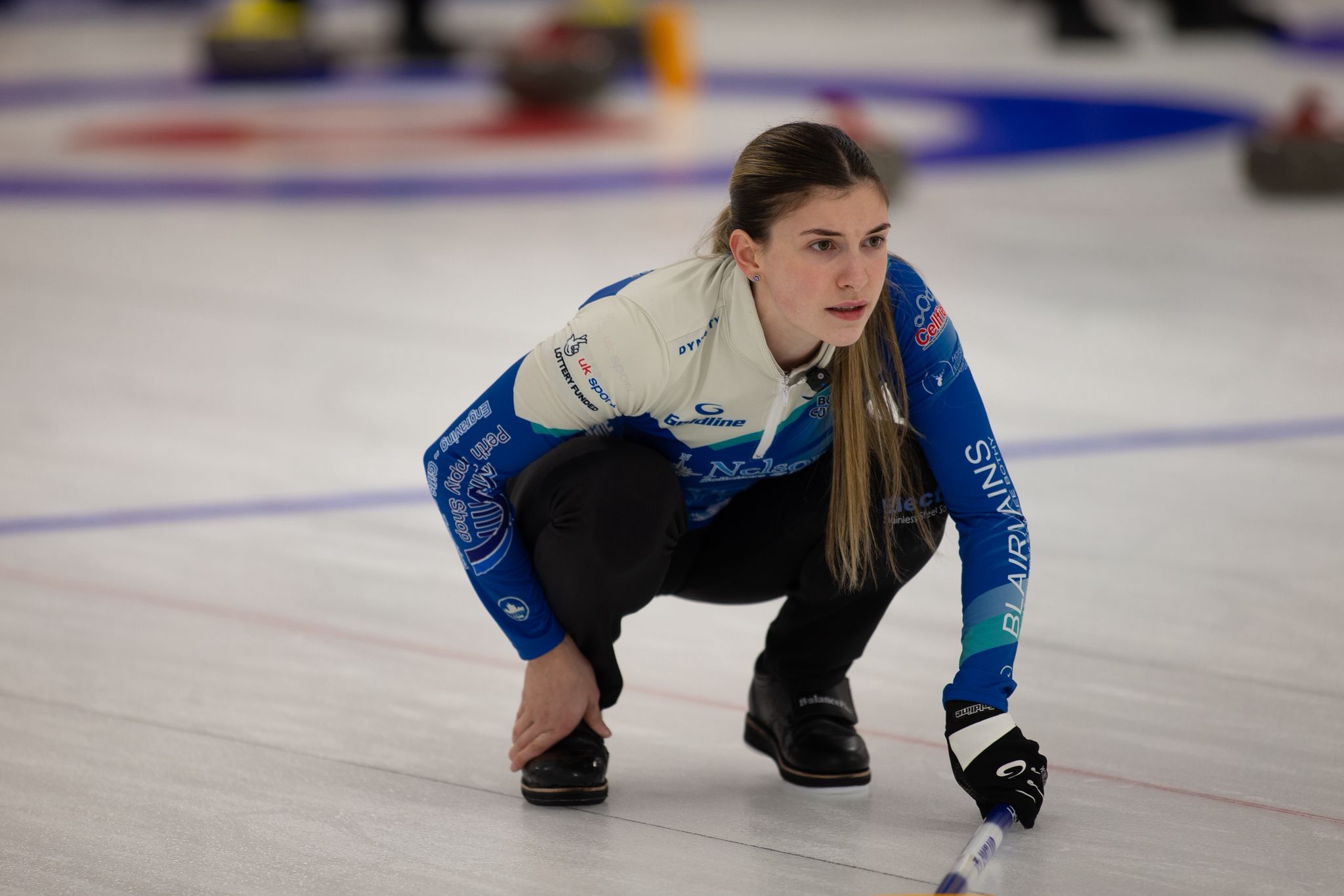 Laura Watt, a sports therapy student at UHI Perth, curling on an ice rink