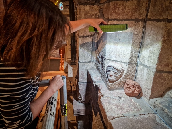 Dr Sarah Jane Gibbon comparing one of the carvings in St Magnus Cathedral to the Skaill head. (Dan Lee)