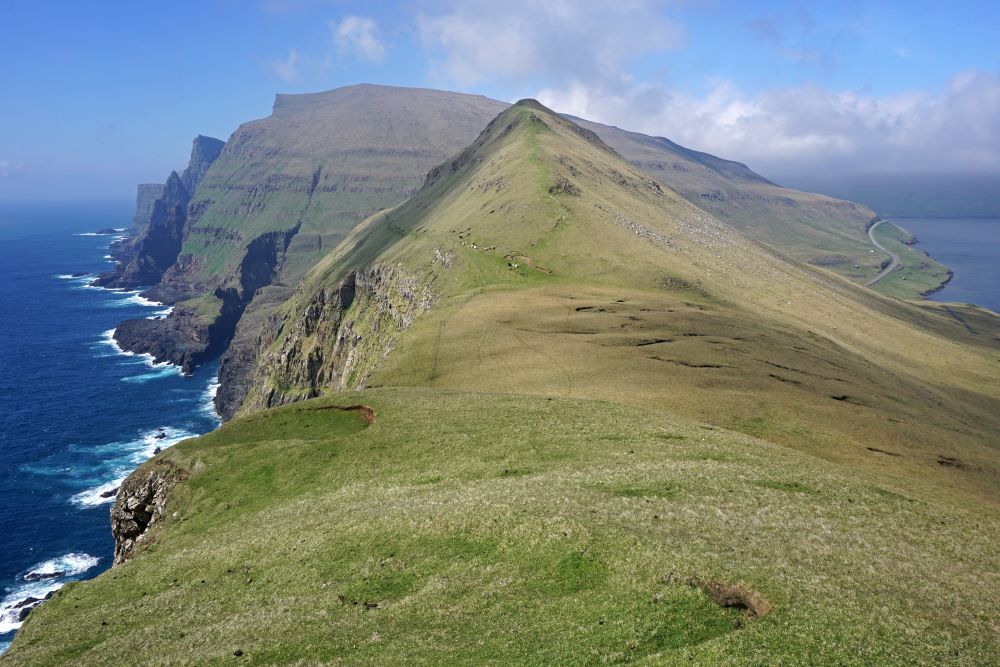 Photograph of View towards Kirvi, near the village Lopra, Faroe Islands. The top of the mountain is called Kirviskollur.