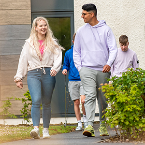Two students walking and chatting