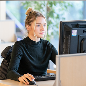 Student studying at a computer desk